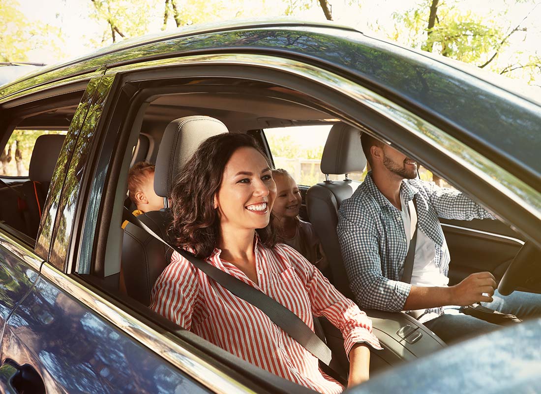 Auto Insurance - Family Driving to a Vacation Destination with Kids in the Back of the Car